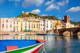 Lais Puzzle - Buntes Boot vor dem Hintergrund der schönen Gebäude von Bosa, Sardinien, Italien - 2.000 Teile